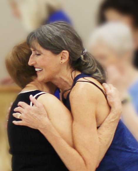 Marcia hugging a person at the end of Marcia's in person Essentrics class.